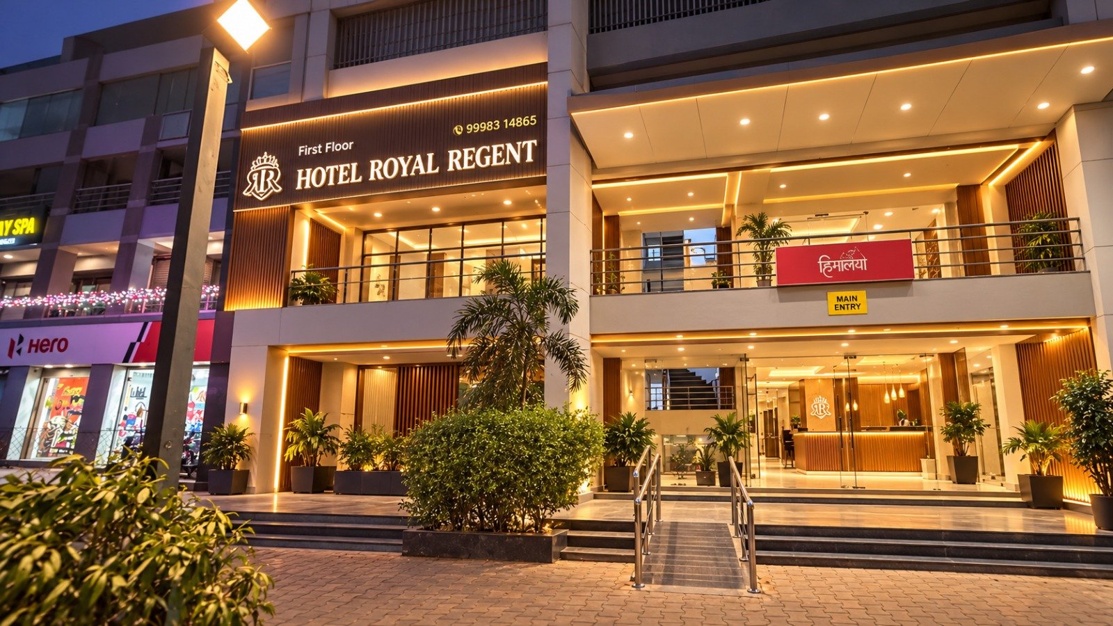 Hotel Royal Regent entrance glowing with warm golden lighting in the evening